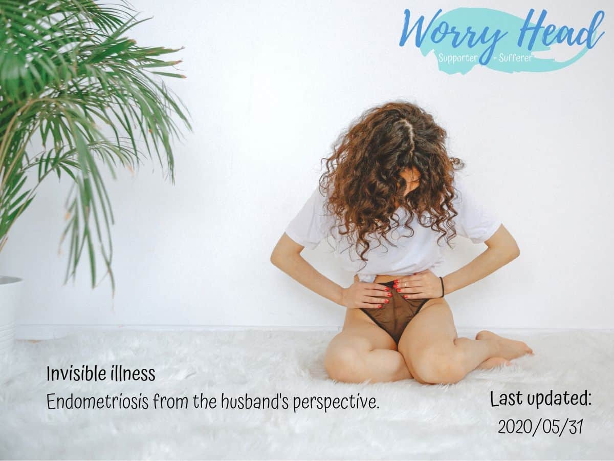 A woman kneeling on the floor in pain.