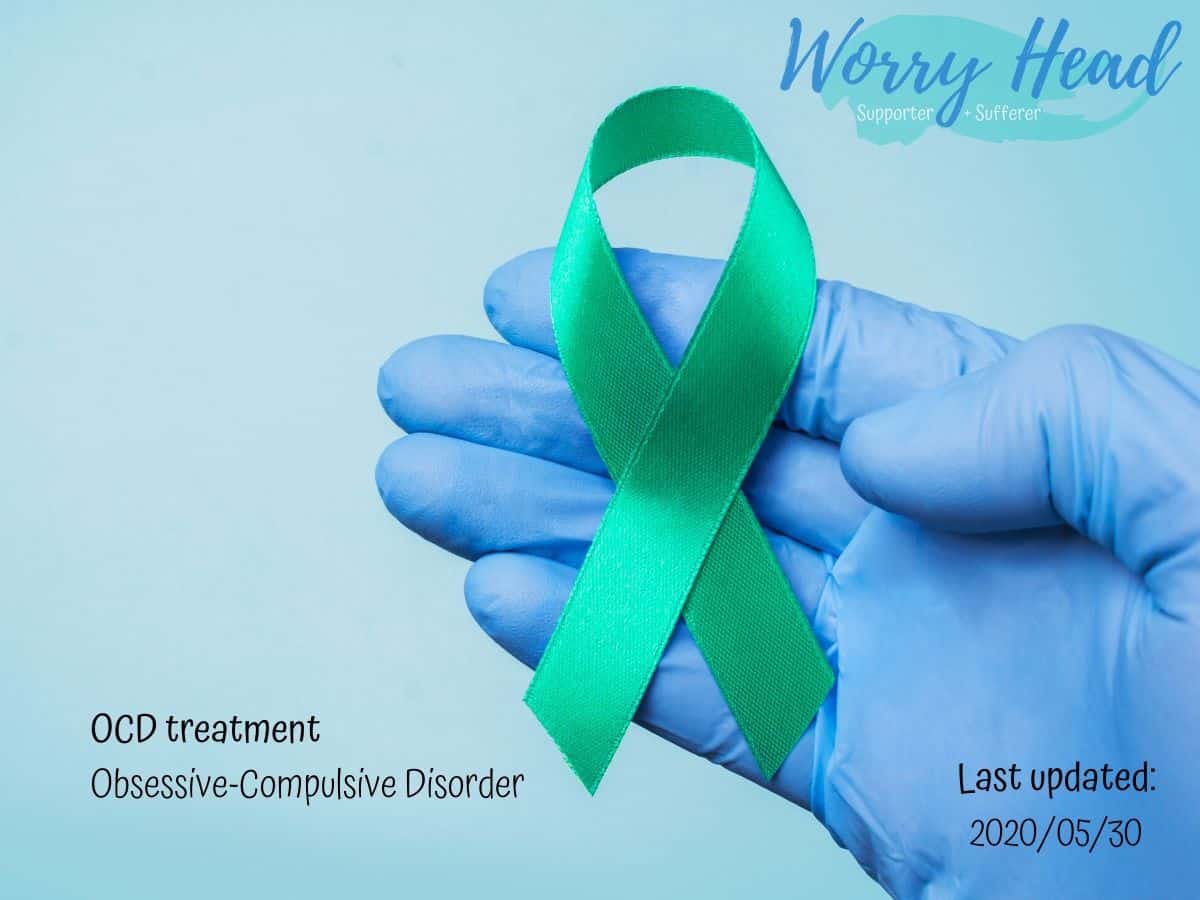 A hand in the glove holding green ribbon.
